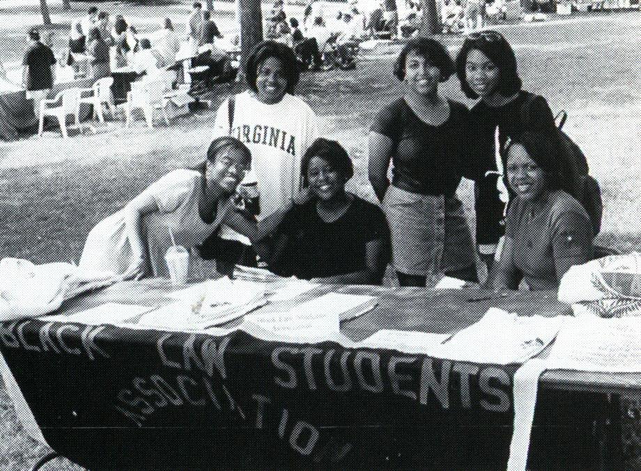 BLSA members table at an event, 1997, Barrister (Law School yearbook).